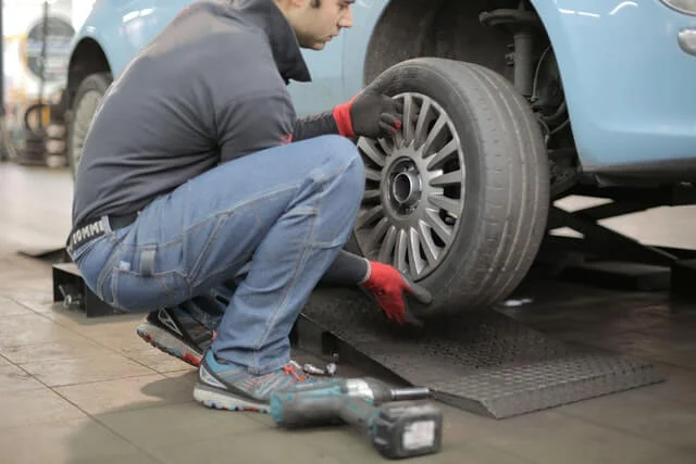 mechanic removing wheel